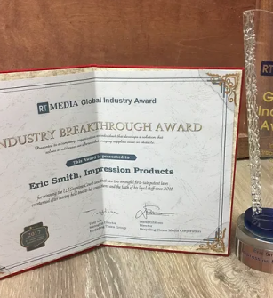 Industry Breakthrough Award certificate and trophy presented to Eric Smith of Impression Products, recognizing innovation.